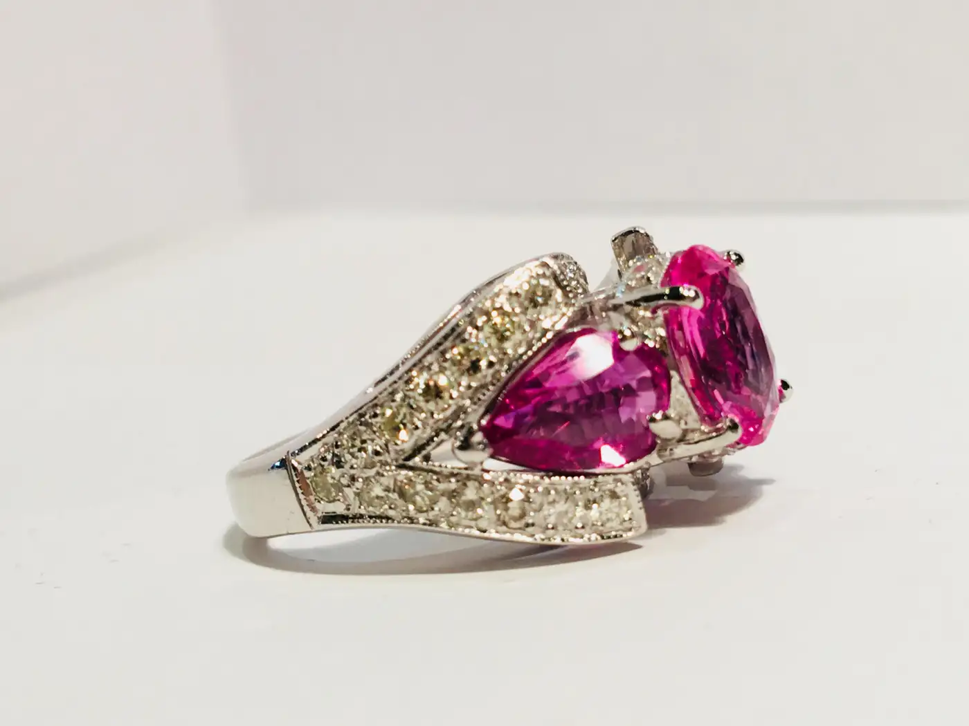 Spectacular-Vivid-Pink-Sapphire-Diamond-Platinum-Three-Stone-Ring-3.webp
